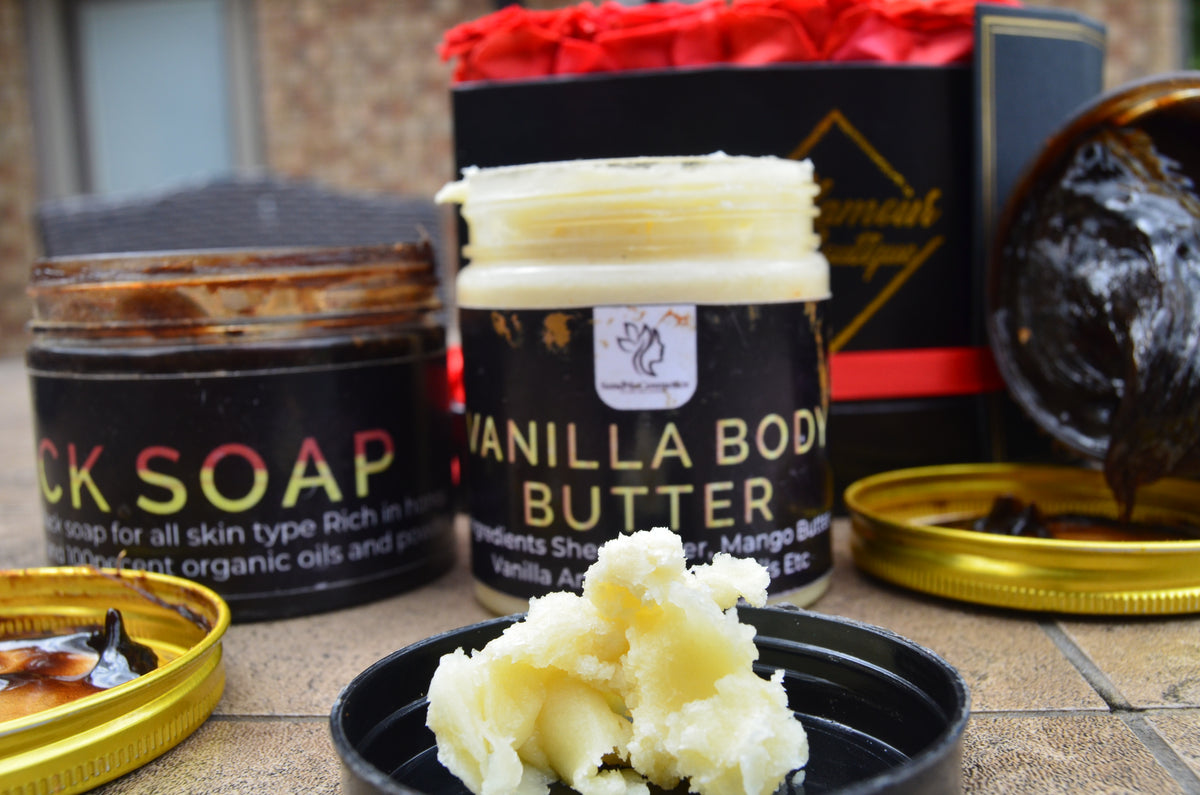 Send Me Cosmetics Vanilla body butter jar with Honey Baked Black Soap and a container of white cream on a tiled surface.